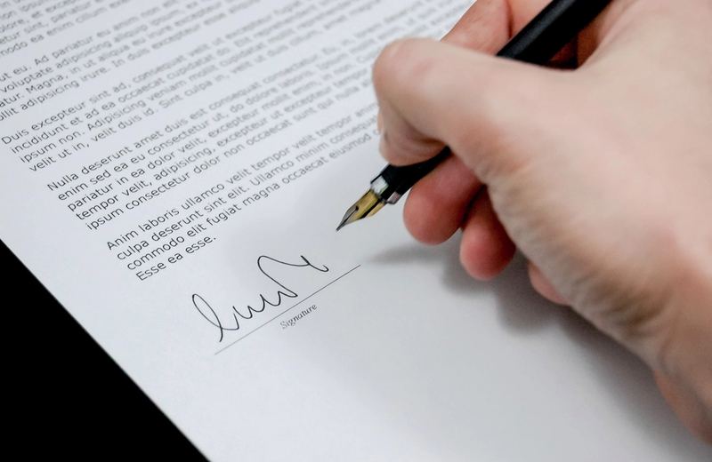 Signing a contract with a fountain pen